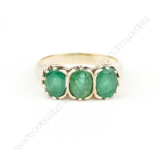 A vintage 9ct. yellow gold three stone emerald ring
