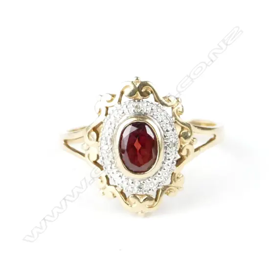 A vintage lady's 9ct. yellow gold garnet and diamond dress ring