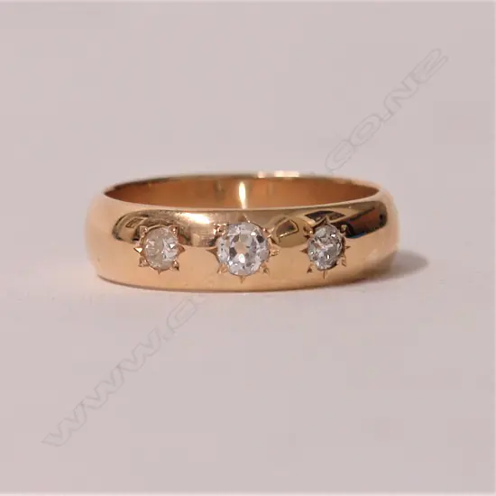 A 14ct. three-stone diamond set gypsy style ring