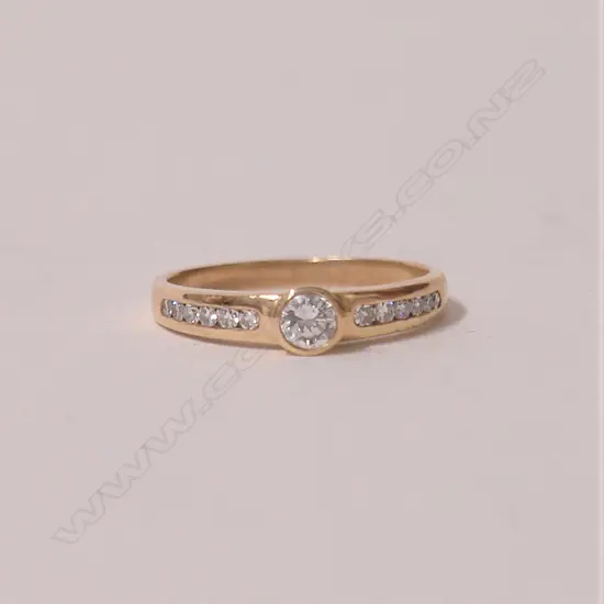 A lady's modern 9ct. yellow gold and solitaire diamond ring
