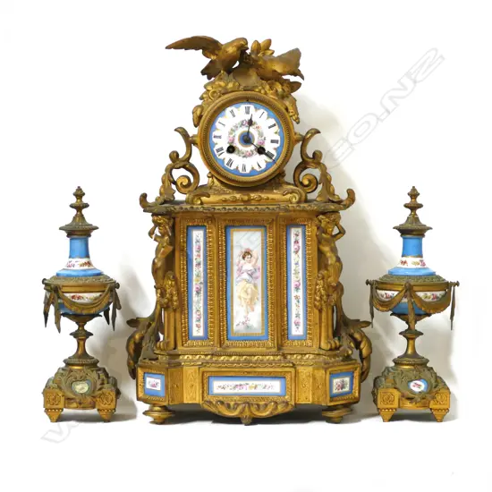 A French gilded and porcelain mantel clock with garnitures