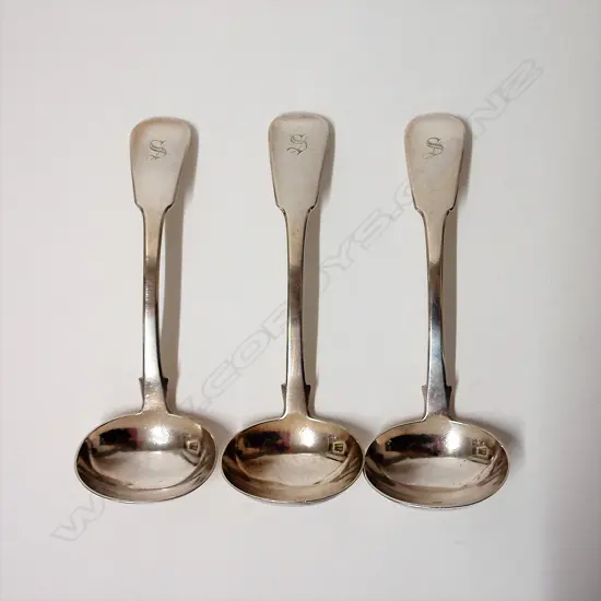 A set of three George III silver sauce ladles