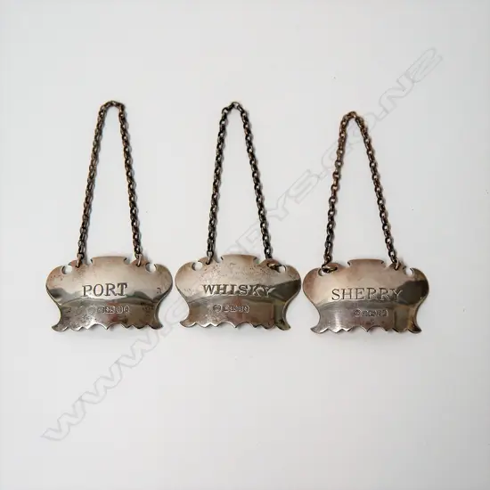 Three 20thC silver bottle tickets