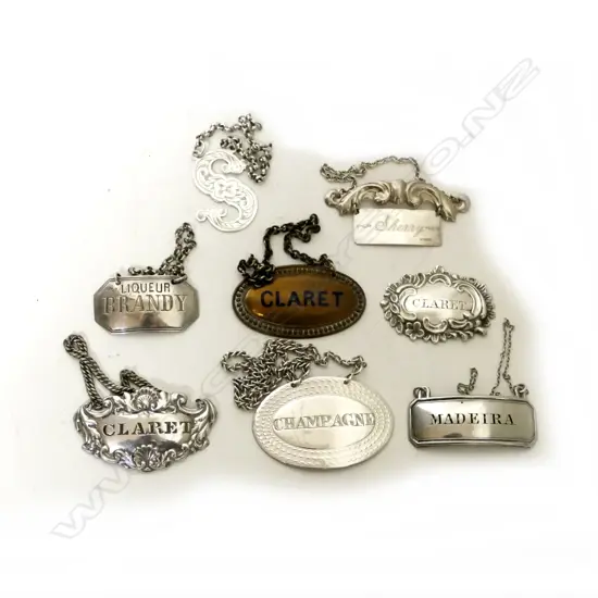 A collection of eight vintage bottle tickets