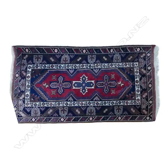 A hand knotted Turkish rug with bold geometric floral designs