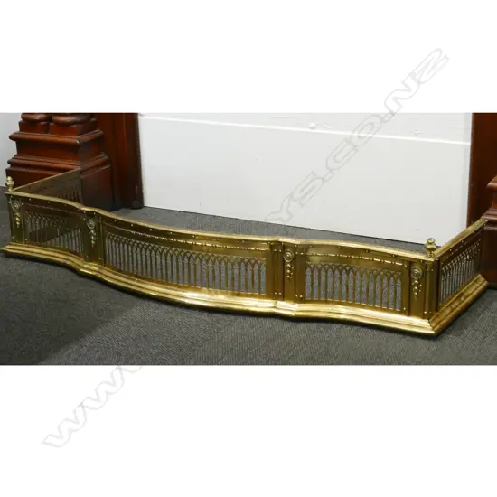 A Victorian brass fire fender