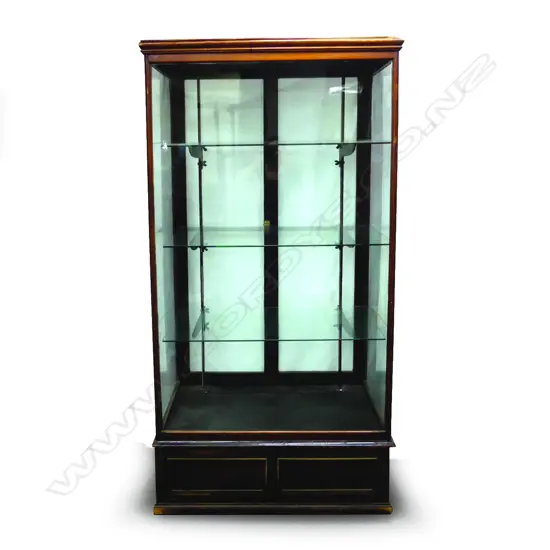 A tall glazed shop display cabinet with mahogany frame