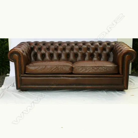 A leather two-seater button-back Chesterfield