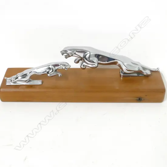 Two Jaguar car mascots