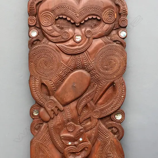An impressive mid-20thC large carved Maori stylised figure panel