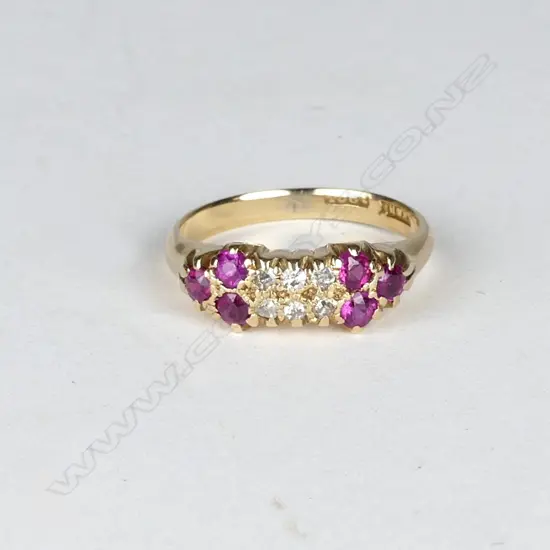 An N.Z. 18ct. gold diamond and faux ruby ring