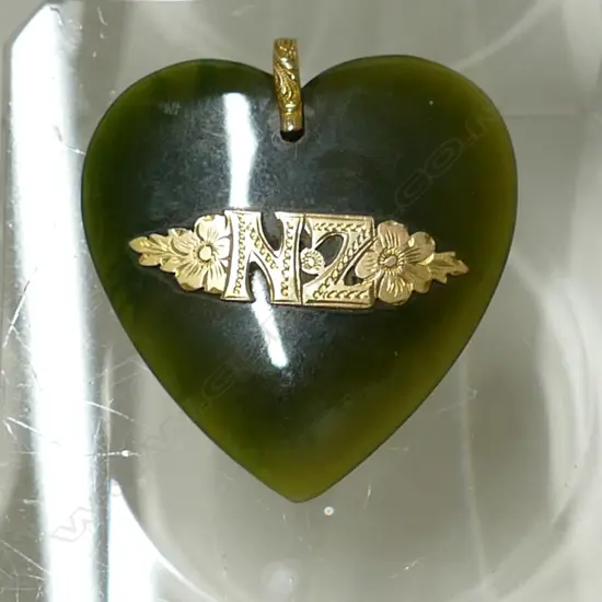 A N.Z. colonial greenstone and 9ct. gold mounted heart pendant