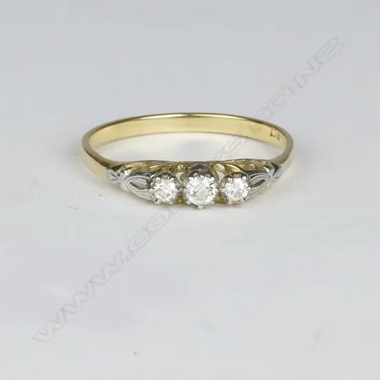 An estate 18ct. gold and three-stone diamond ring
