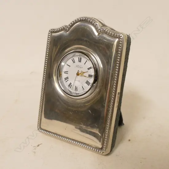 A small silver boudoir clock