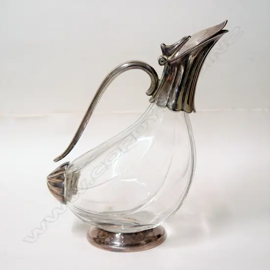 A silver plate and glass bodied wine decanter