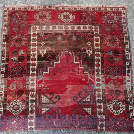 A hand knotted Turkish rug with geometric floral motifs
