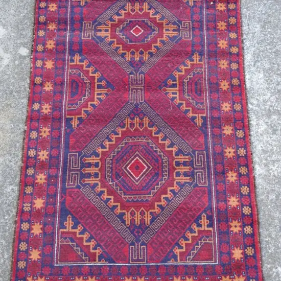 A small hand knotted Baluchi tribal rug