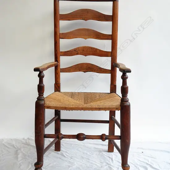An early 19thC elm and beech country ladder back armchair