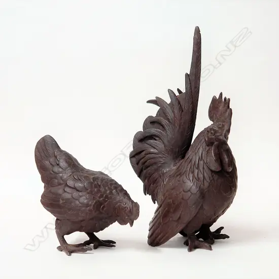 An early 20thC bronzed metal rooster and hen