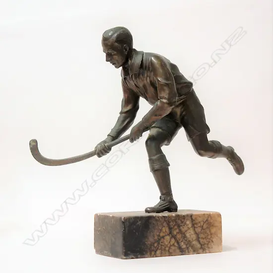 An Art Deco spelter figure of a hockey player