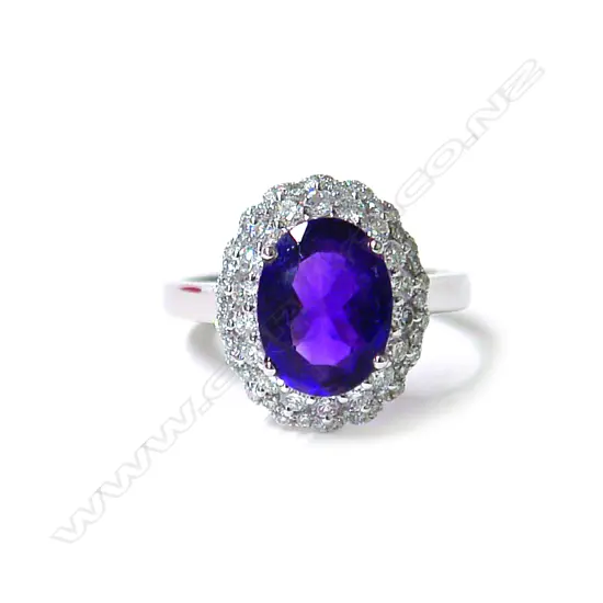 A modern 18ct. white gold amethyst and diamond cluster ring