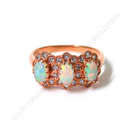 A lady's modern 18ct. yellow gold three opal and diamond cluster ring