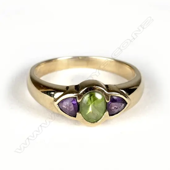 An estate 9ct. gold amethyst and peridot dress ring