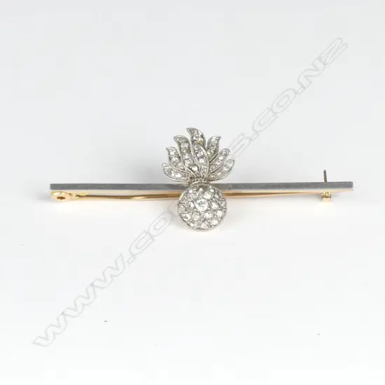 An 18ct. yellow and white gold diamond set military 'Shell and Flame' brooch