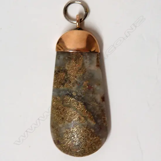 A N.Z. colonial 9ct. rose gold capped gold bearing quartz pendant