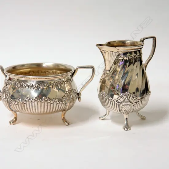 A pair of late Victorian silver Chippendale style sugar and cream