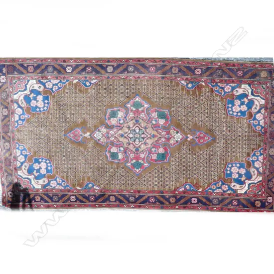 A large old hand knotted Persian Hamadan rug