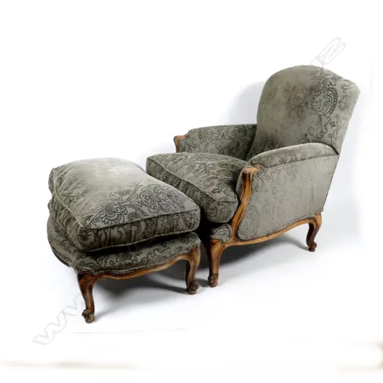 A large French style armchair and matching ottoman stool