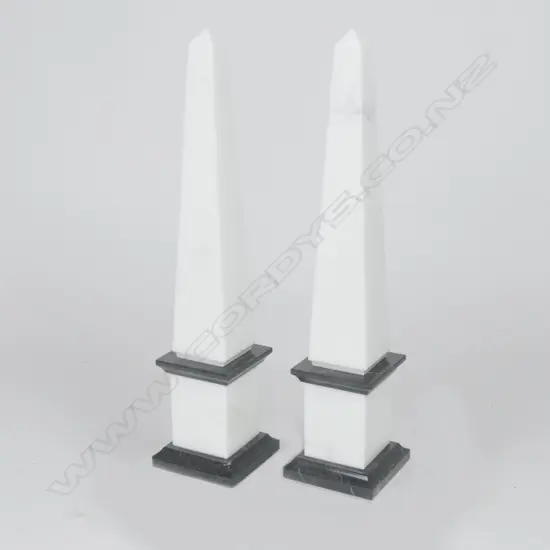 A pair of white and black marble mantel obelisks