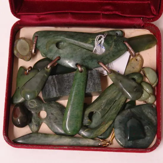 A collection of carved greenstone pendants etc.
