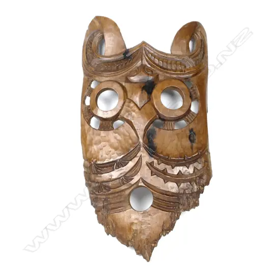 A Maori mask carved from a slab of matai