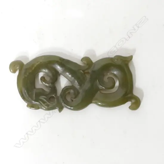 A Chinese brown/green jade carving of a sinuous qilin