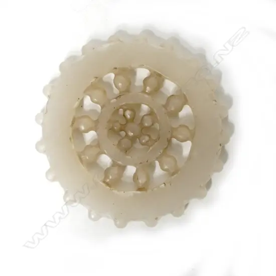 A Chinese white jade carved Buddhist wheel