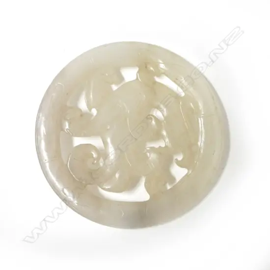 A Chinese muttonfat jade circular pendant disc
