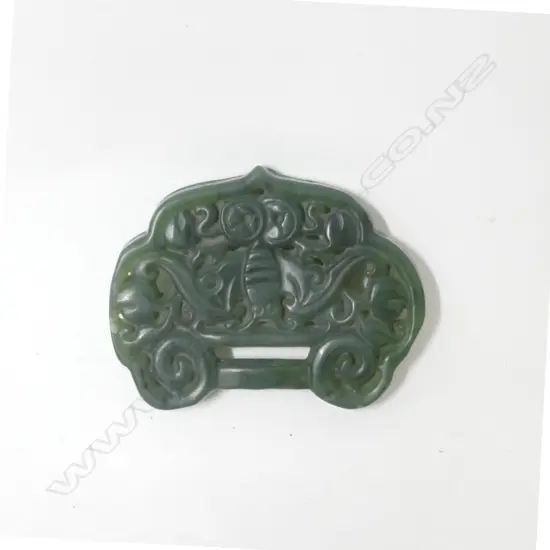A Chinese green jade ribbon pendant