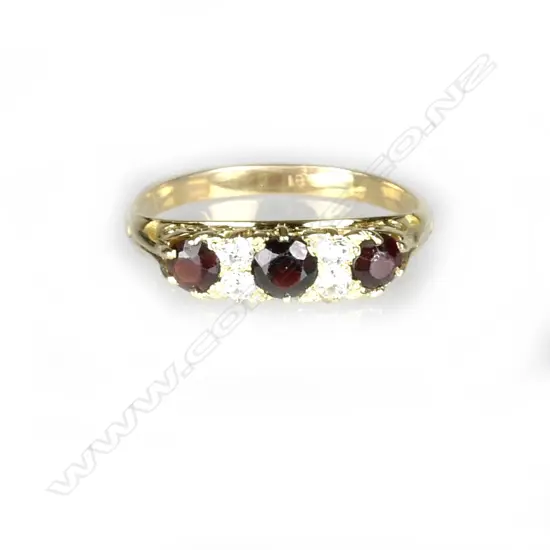 An 18ct. yellow gold garnet and diamond bridge ring