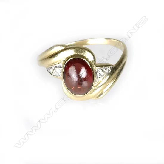 An 18ct. yellow gold garnet and diamond ring