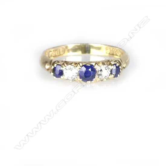 An 18ct. yellow gold natural sapphire and diamond bridge ring