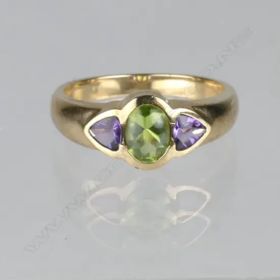 A 9ct. rose gold peridot and amethyst ring