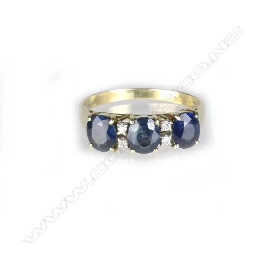 An 18ct. yellow gold three stone sapphire ring
