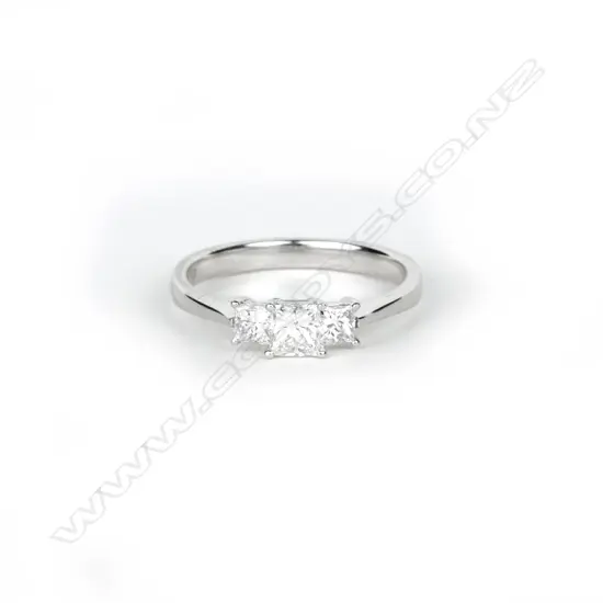 An 18ct. white gold and three stone diamond ring