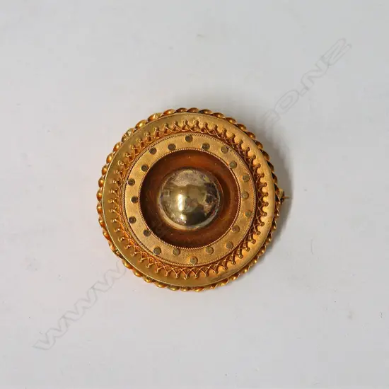 A Victorian Etruscan 15ct. yellow gold circular brooch