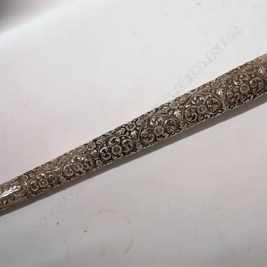 An Eastern silver finely embossed cane handle