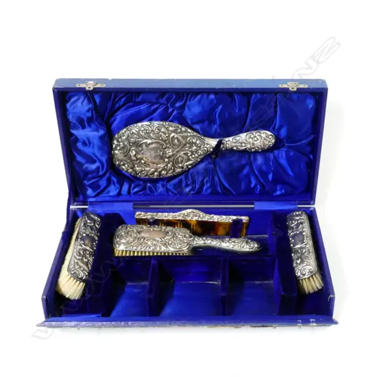 A cased set of vanity brushes