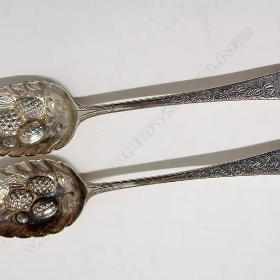 A pair of George III silver berry spoons
