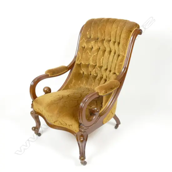 A Victorian mahogany open elbow library chair